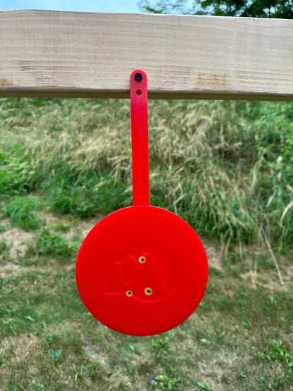 red self healing target at outdoor shooting range the gun target has changed color from bullets