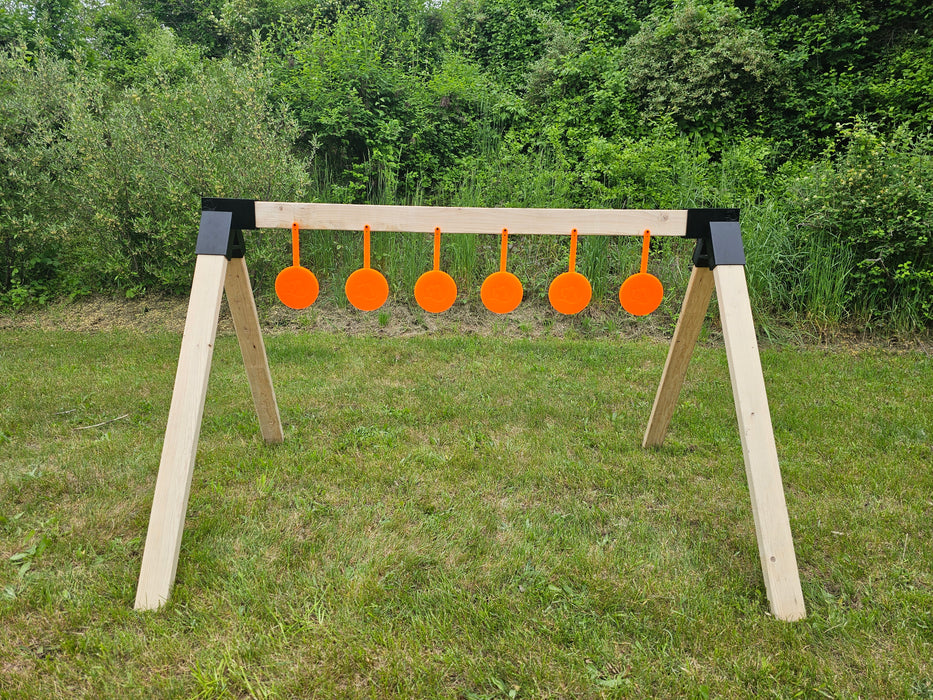 a row of bright orange self healing targets that are reactive shooting targets