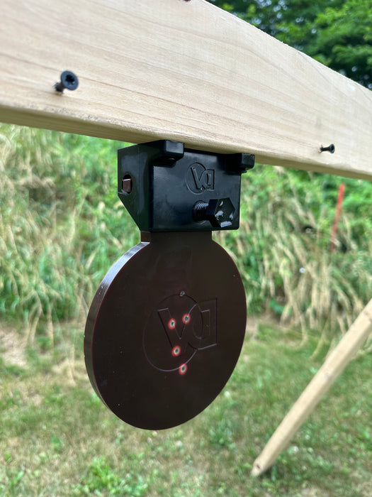 black knockdown target mounted upside down used as a swinging target for pistol shooting