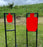 two red silhouette shooting targets mounted to shooting stand at gun shooting range