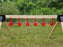 row of red shooting targets at an outdoor range