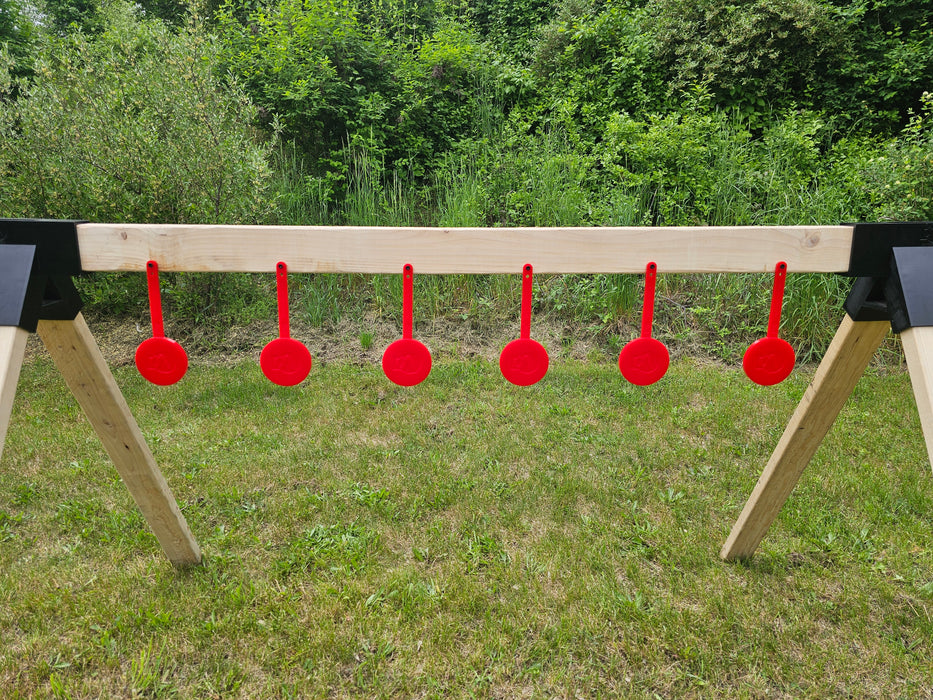 row of red shooting targets at an outdoor range