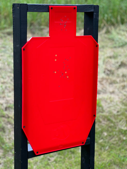 color changing full size uspsa target with yellow marks from 9mm pistol shooting at outdoor range